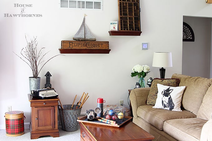 A rustic vintage eclectic style summer home decor tour including vintage thermoses, cameras, typewriter and vintage croquet and badminton equipment.