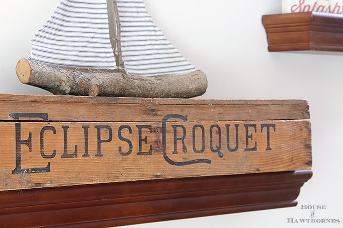 A rustic vintage eclectic style summer home decor tour including vintage thermoses, cameras, typewriter and vintage croquet and badminton equipment.