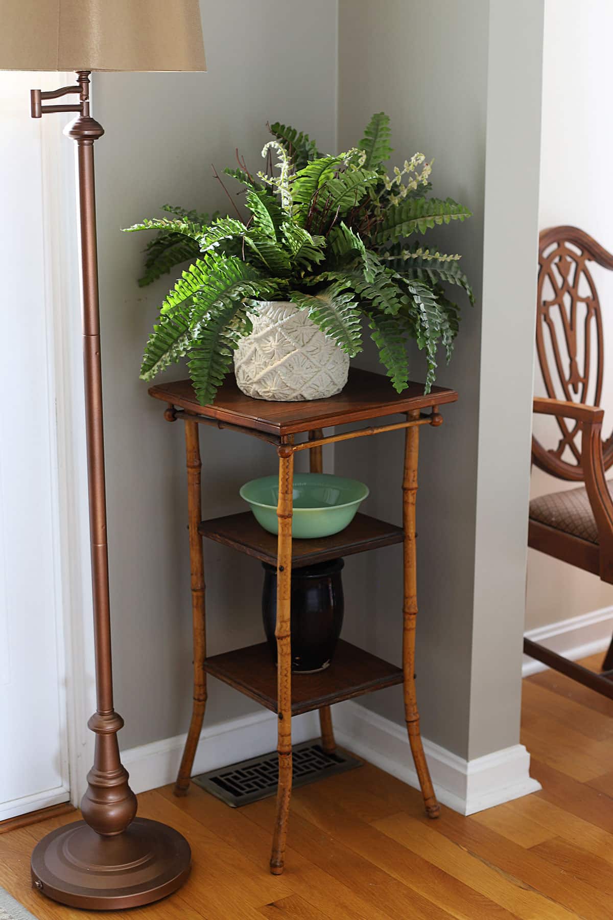 Bamboo side table used as a plant stand.