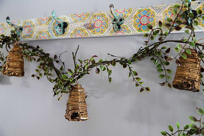 Bee skep garland on boho coat rack