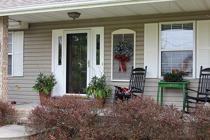 Festive Christmas porch decorations that transition easily from Christmas to winter are found on our rustic, farmhouse, plaid and nature inspired porch.