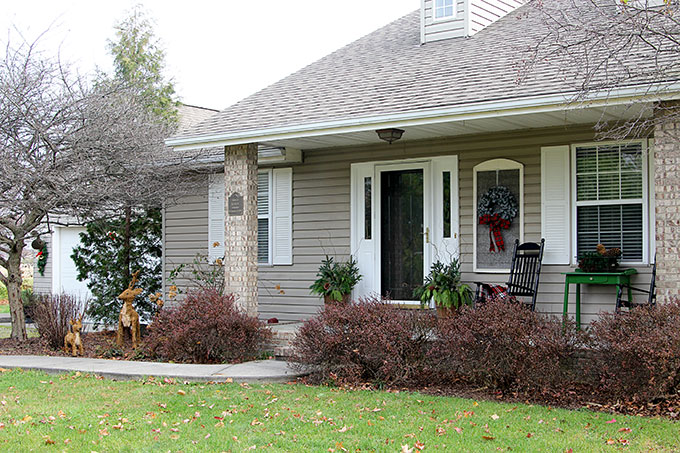 Festive Christmas porch decorations that transition easily from Christmas to winter are found on our rustic, farmhouse, plaid and nature inspired porch.