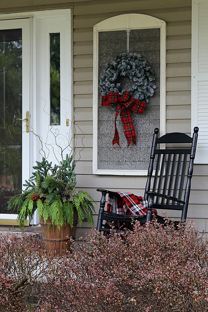 Festive Christmas porch decorations that transition easily from Christmas to winter are found on our rustic, farmhouse, plaid and nature inspired porch.