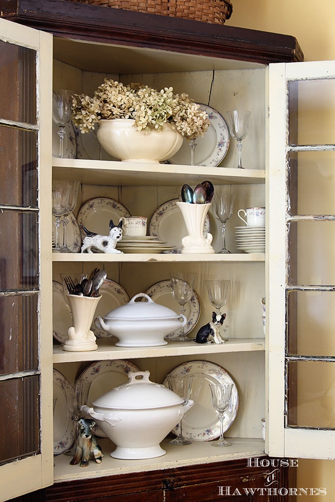 Corner cupboard filled with ironstone