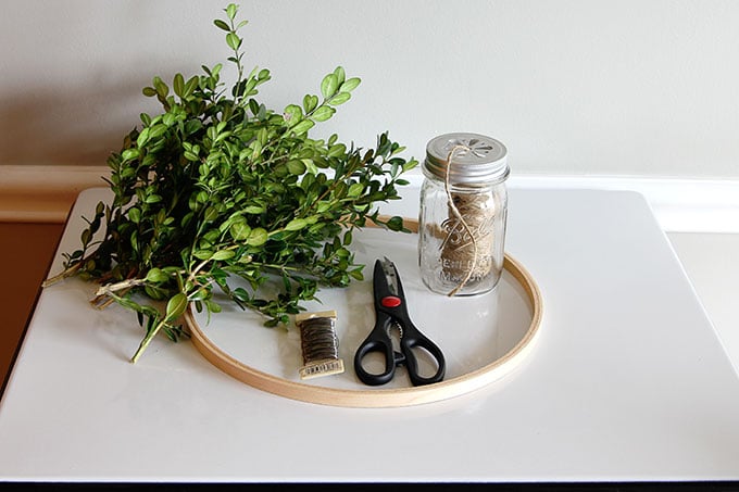 Learn how to make a super quick and easy boxwood wreath. And did I mention it is cheap? Perfect for the holidays, yet looks great any time of the year.