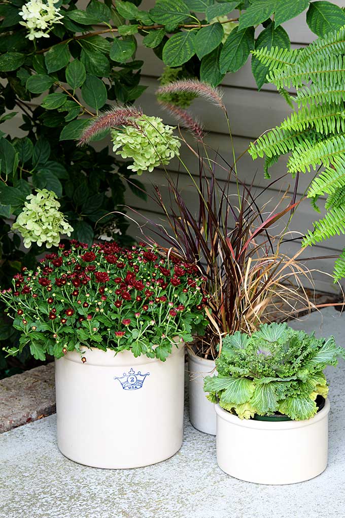 Crocks used as fall porch decor