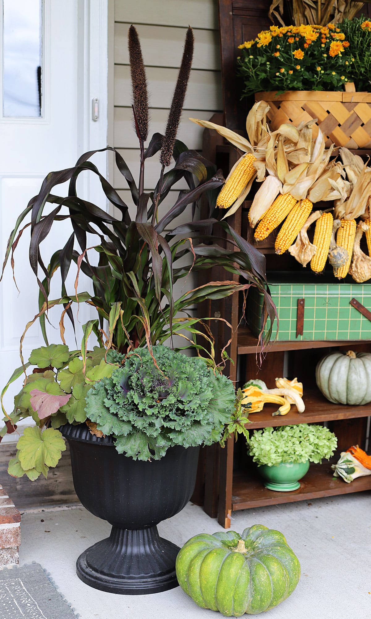 Unique fall foliage plants in a container garden on the front porch. Includes coral bells, millet and ornamental cabbage.