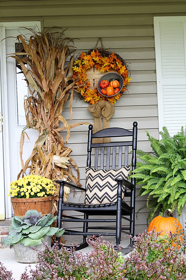 Cornstalks and chrysanthemums for traditional outdoor fall decorations.