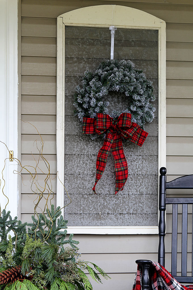 Festive Christmas porch decorations that transition easily from Christmas to winter are found on our rustic, farmhouse, plaid and nature inspired porch.