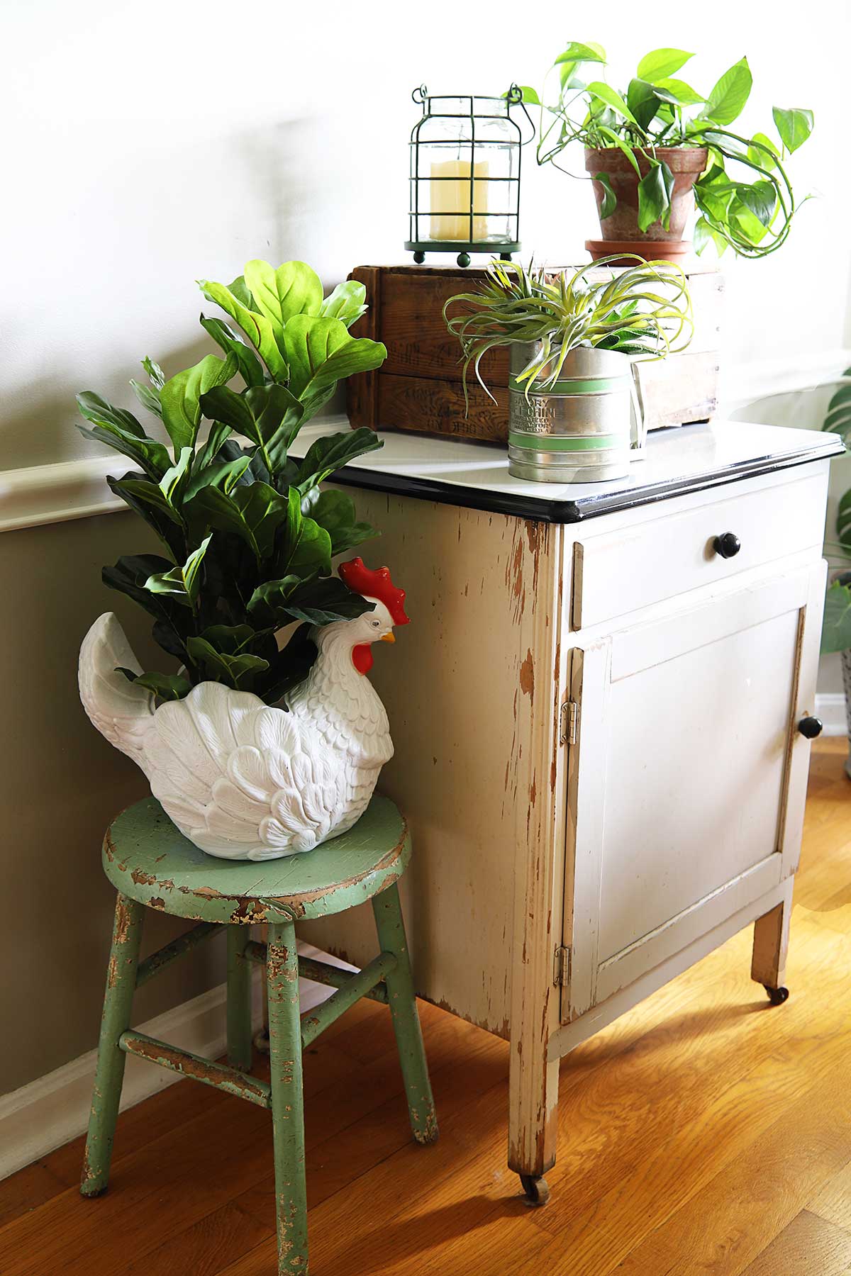 farmhouse vignette using vintage kitchen cabinet with enamel top