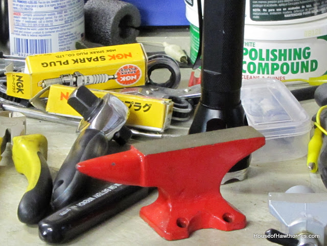 red anvil used to stamp letters on silverware