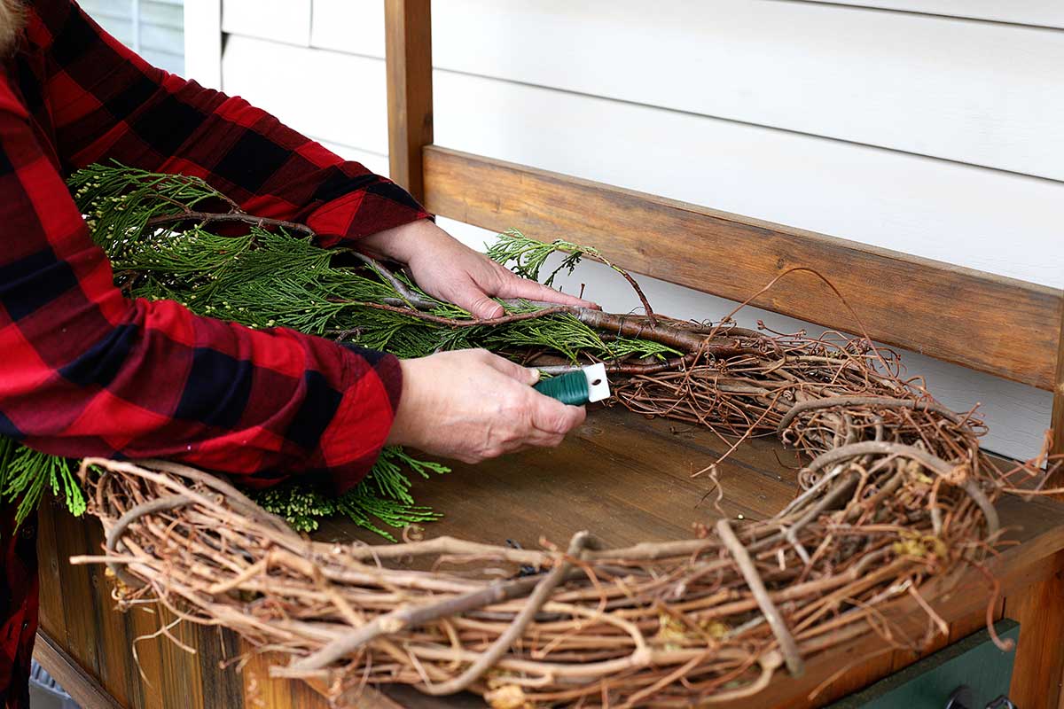 wrapping paddle wire around greens for wreath