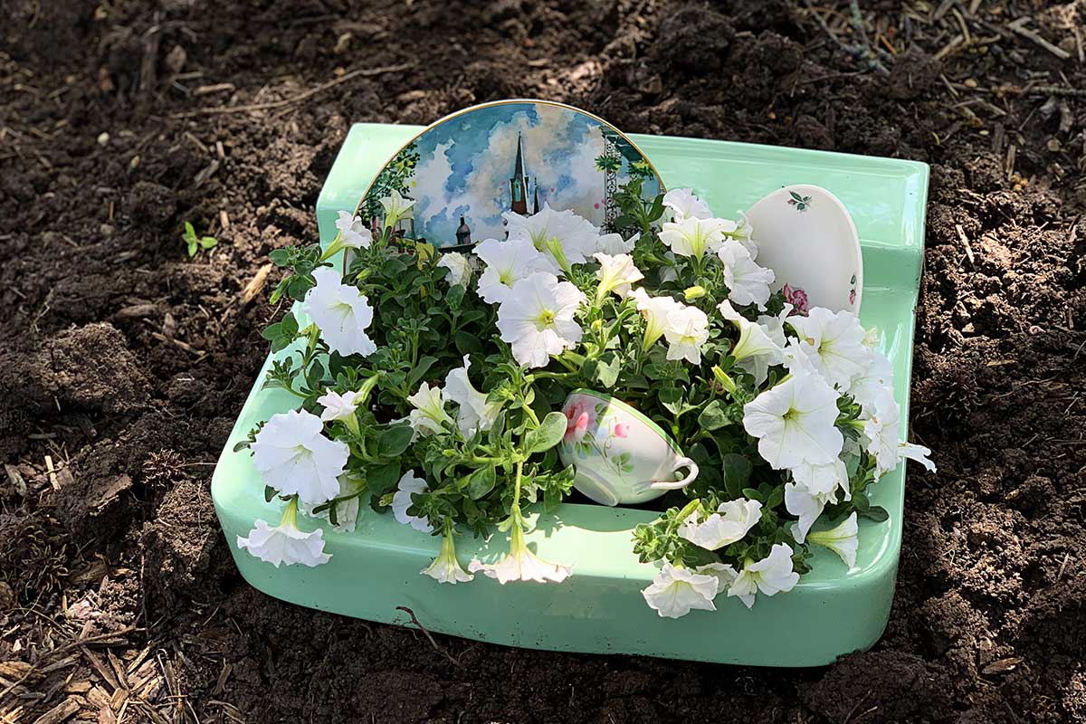 plates and cups added to repurposed sink planter