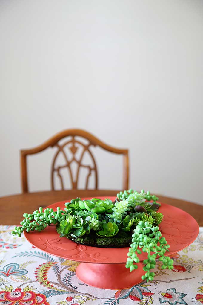 Learn how to make a super cute boho style succulent garden from a repurposed thrift store tray. A quick and easy upcycling idea that can use either artificial or living succulents for a bright and colorful DIY succulent garden. #diygarden #thrift #upcycling #upcycled #repurposed #junkgardening