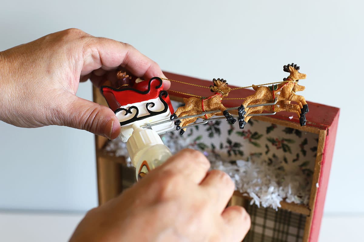 gluing santa sleigh for Christmas shadowbox