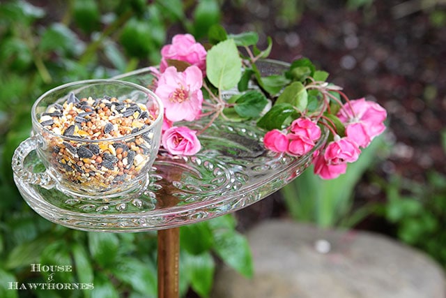 Vintage glass snack set repurposed into a bird feeder