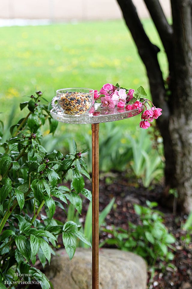 Vintage glass snack set repurposed into a bird feeder