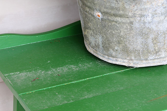 Green farmhouse table used on the front porch