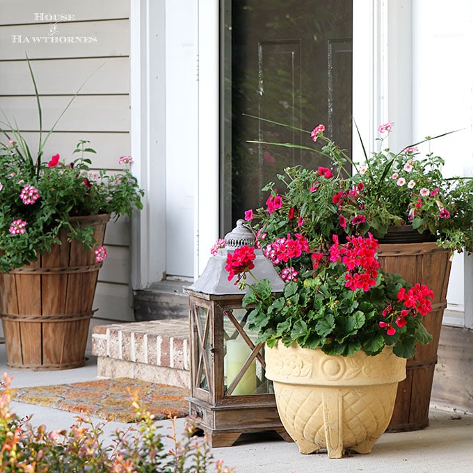 Summer porch decorating ideas and inspiration using farmhouse touches, vintage items, plenty of annual flowers and a healthy dose of patriotic decor. 