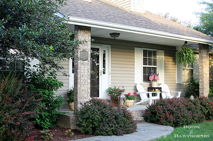 Summer porch decorating ideas and inspiration using farmhouse touches, vintage items, plenty of annual flowers and a healthy dose of patriotic decor. 