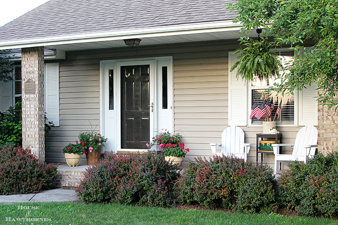 Summer porch decorating ideas and inspiration using farmhouse touches, vintage items, plenty of annual flowers and a healthy dose of patriotic decor. 