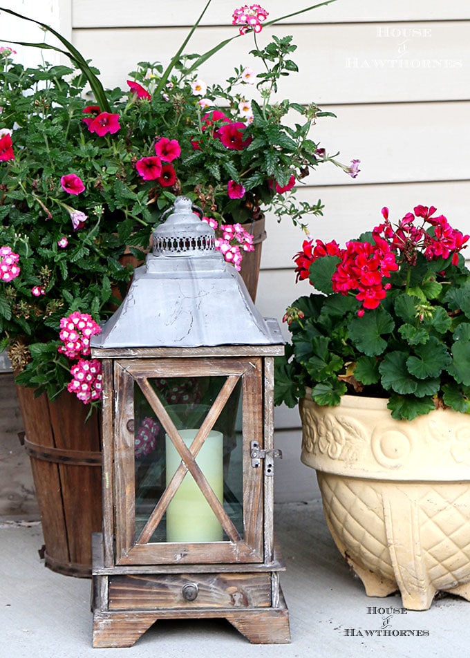 Summer porch decorating ideas and inspiration using farmhouse touches, vintage items, plenty of annual flowers and a healthy dose of patriotic decor. 