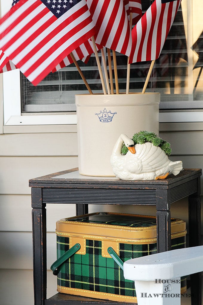 Summer porch decorating ideas and inspiration using farmhouse touches, vintage items, plenty of annual flowers and a healthy dose of patriotic decor. 