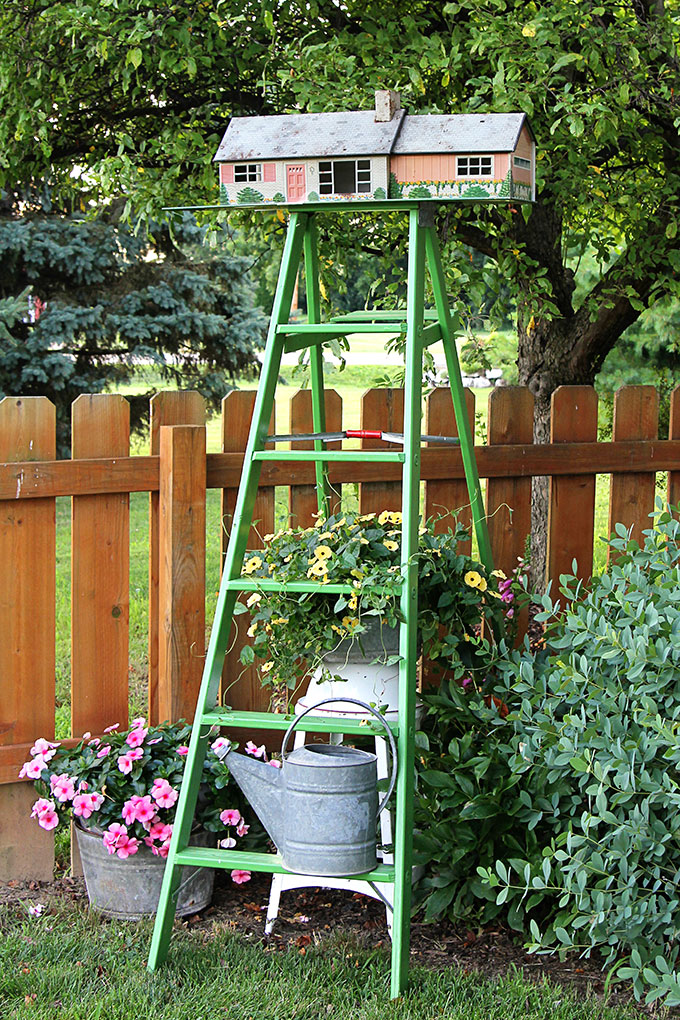 Vintage tin dollhouse turned into a birdhouse