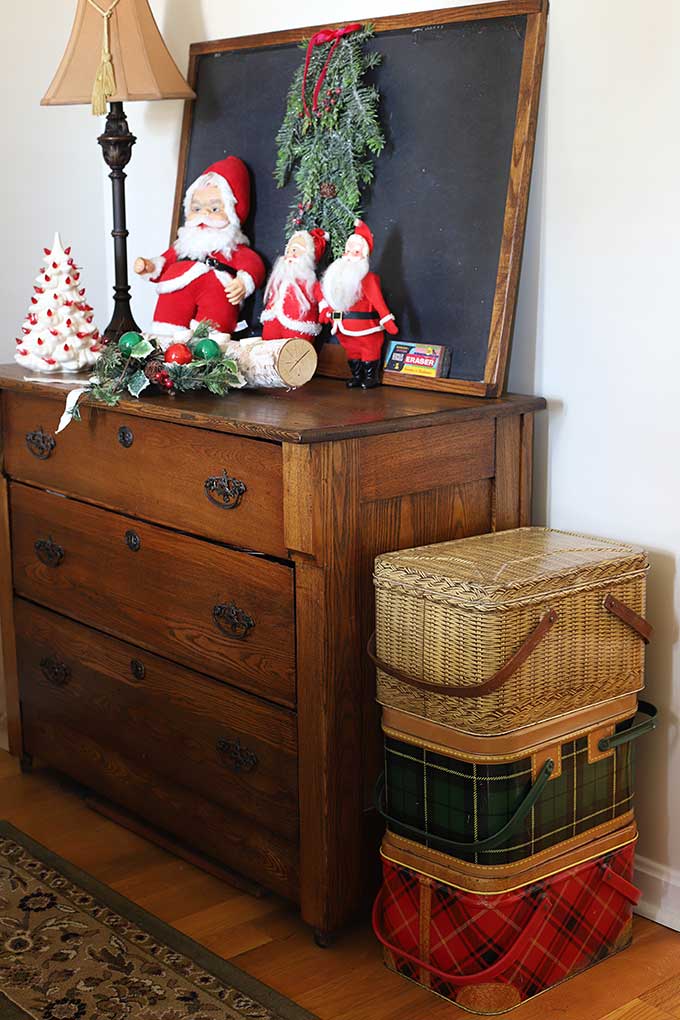 Metal picnic baskets stacked as Christmas decor