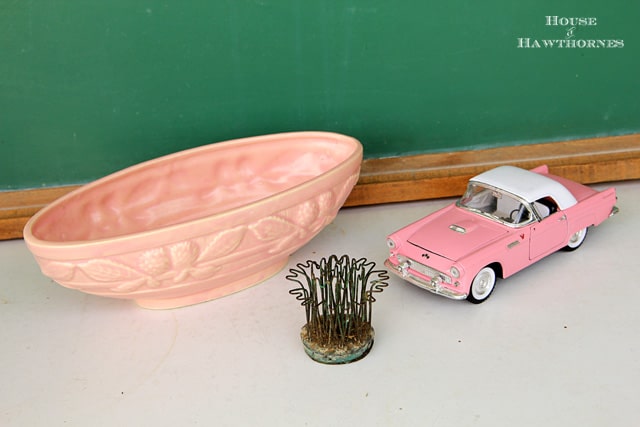 Pink McCoy planter with pinecones.