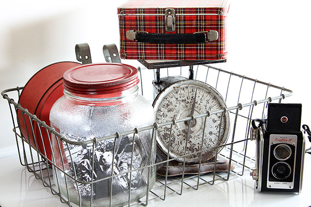 Eclectic vintage vignette with Kodak Duaflex camera, plaid Aladdin lunch box and rusty scale