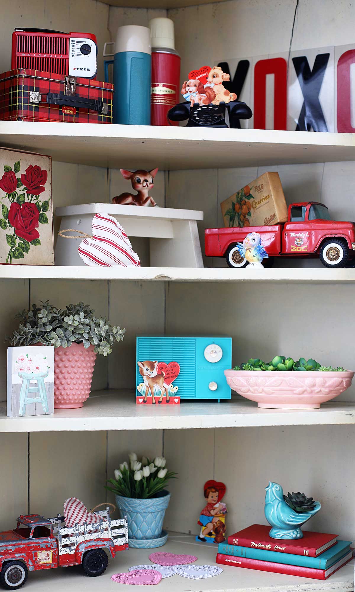 Vintage Valentines Day decor displayed in a bookshelf