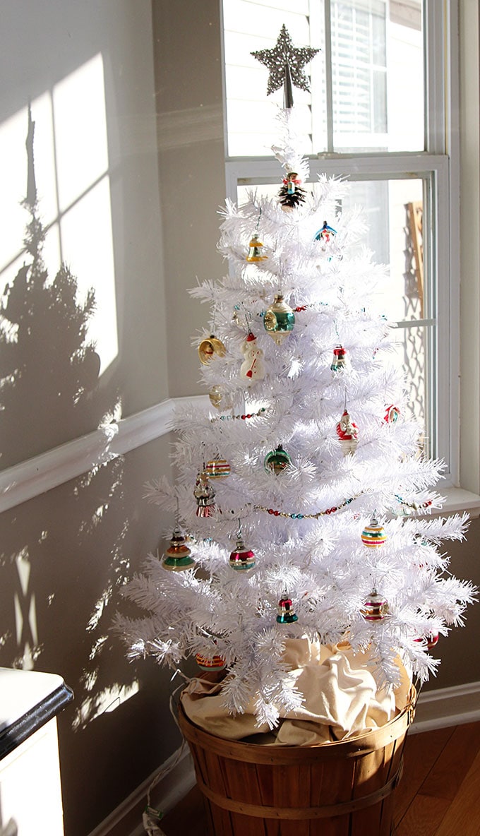 A white Christmas tree with vintage Shiny Brite ornaments