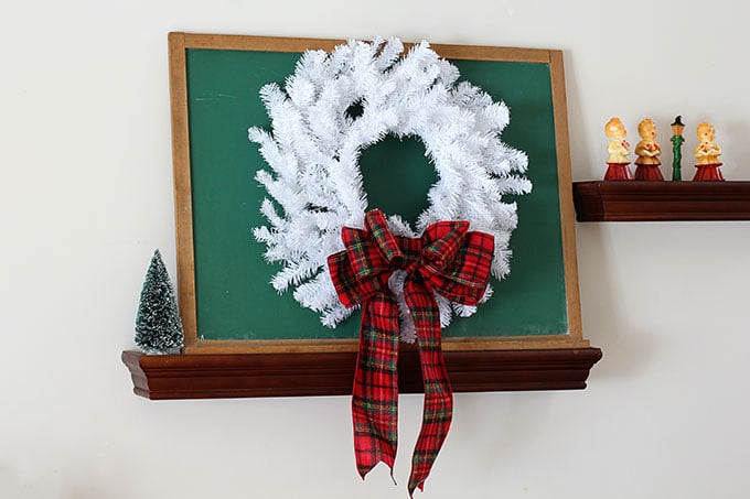 White wreath on a green chalkboard