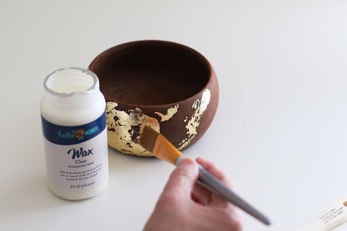 Applying was to the wooden bowl to protect the gold leaf.